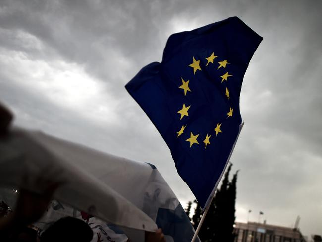 A pro-euro protester holds a European Union flag.