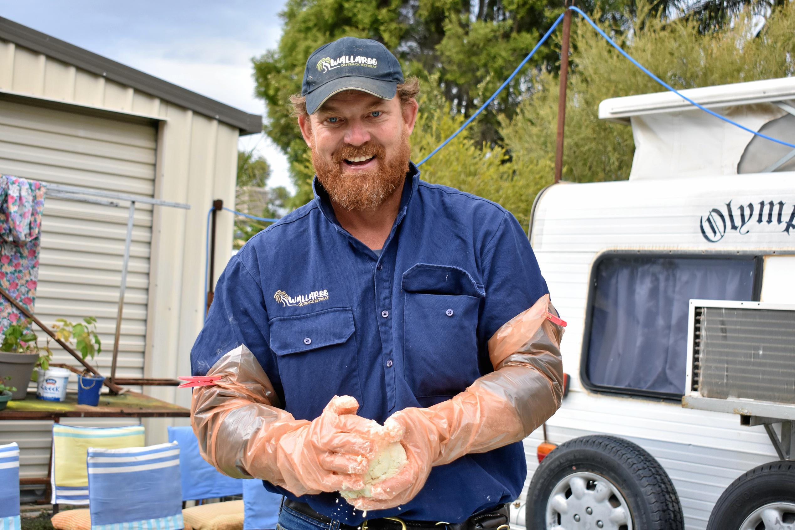 Justin MacDonnell prepares his damper for Injune's Biggest Morning Tea. Picture: Ellen Ransley