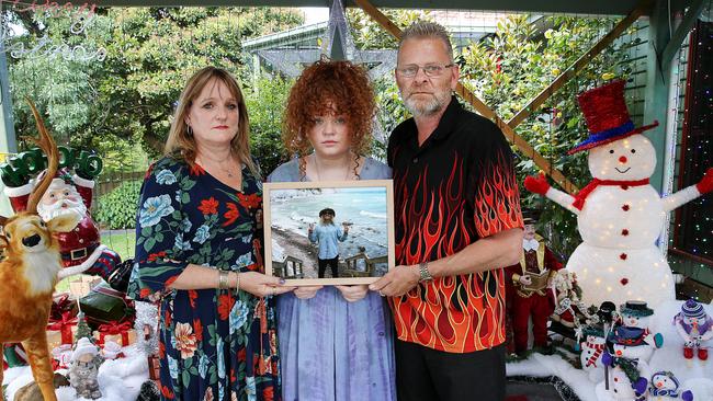 Debbie, Tiarnie and Lee Brasher with a photo of Corey. Picture: Ian Currie