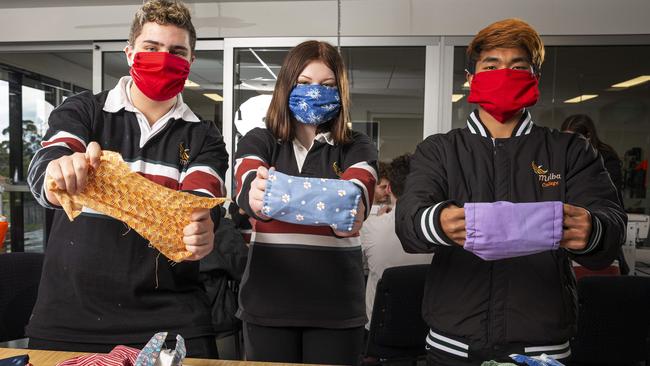 Melba College students Deacon, Haylee and Sangpu get in the mask-making spirit. Picture: Daniel Pockett.