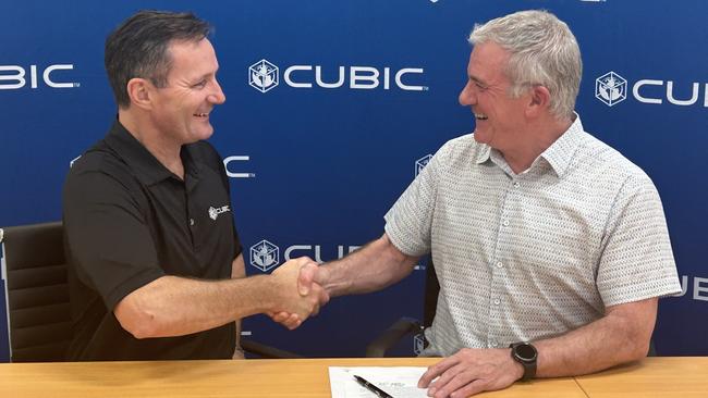 Mark Horn, senior director strategic development at North Queensland-based Cubic, and Lieutenant General (ret.) John Caligari, chair of NQ Spark, celebrate the signing of a memorandum of understanding between the two organisations in Townsville. Picture: Supplied