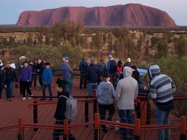 Tourists waiting to make the controversial climb. Picture: @koki_mel_aus/AFP