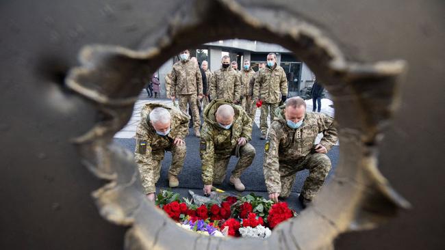 Ukrainian servicemen laying flowers for their fallen comrades at the Memorial Bell in Kiev on Thursday. Picture: AFP