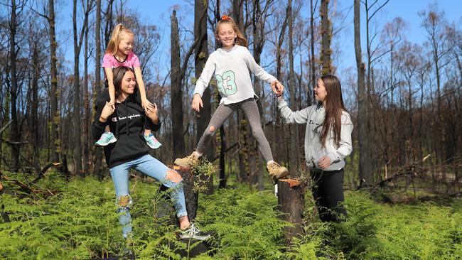 Hannah, 13, with Gracie, 6, Leah, 11, and Kayla, 15, in the regrowth forest. Picture: Alex Coppel