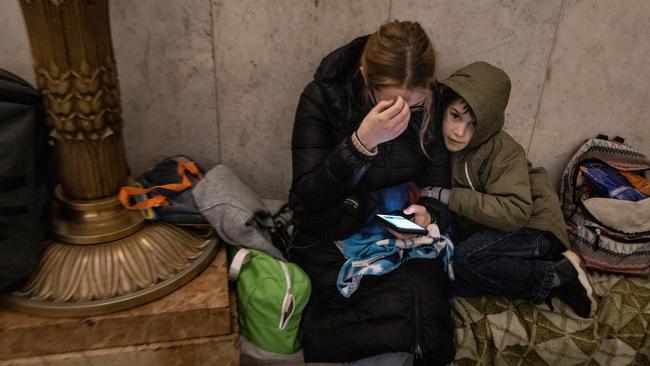 People shelter in a subway station before a curfew comes into effect in Kyiv. Picture: Chris McGrath/Getty Images