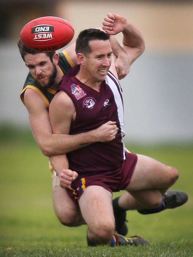 O’Sullivan Beach/Lonsdale’s Daniel Goodwin is tackled heavily by Marion’s Max McCallum on Saturday. Picture: AAP Image/Dean Martin.