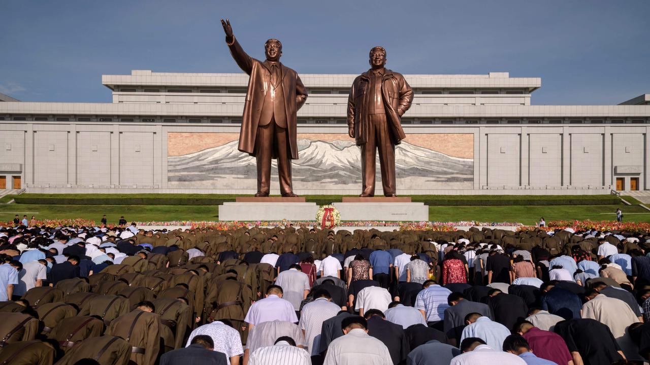 People bow before the statues of the late North Korean leaders Kim Il-sung and Kim Jong-Il as the country marks the 25th death anniversary of Kim Il-sung. Picture: Kim Won Jin/AFP