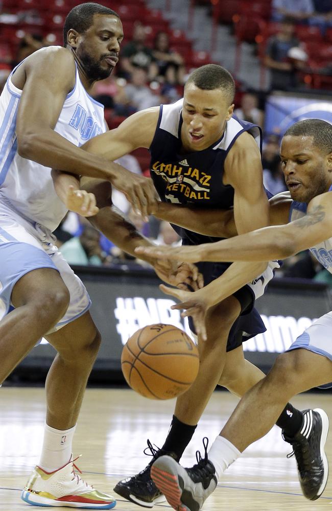 Utah Jazz's Dante Exum, centre, reaches for a loose ball with Denver Nuggets' Will Thomas, left, and Chris Wright during the first half of an NBA Summer League game.