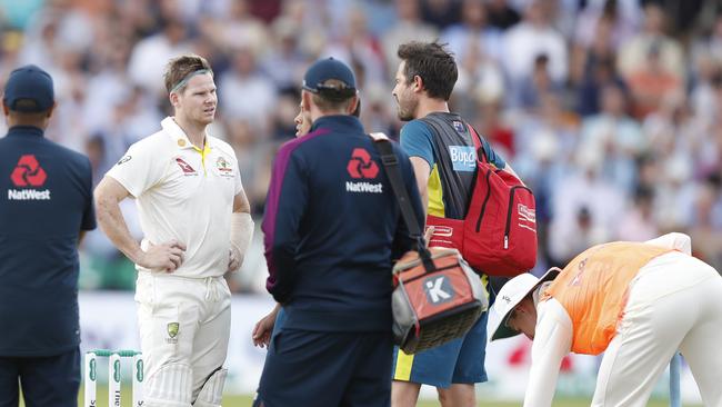 Steve Smith receives treatment on the field after being struck in the head. Picture: AP Photo/Alastair Grant