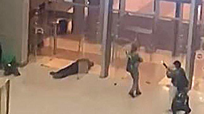 This image grab taken from footage obtained by AFP TV shows unidentified gunmen moving towards the doors of the Crocus City Hall in Krasnogorsk, outside Moscow. Picture: AFP.