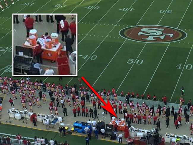 Kaepernick can be seen here, seated between the orange water dispensers while the US national anthem plays. Picture: Twitter / @jenniferleechan
