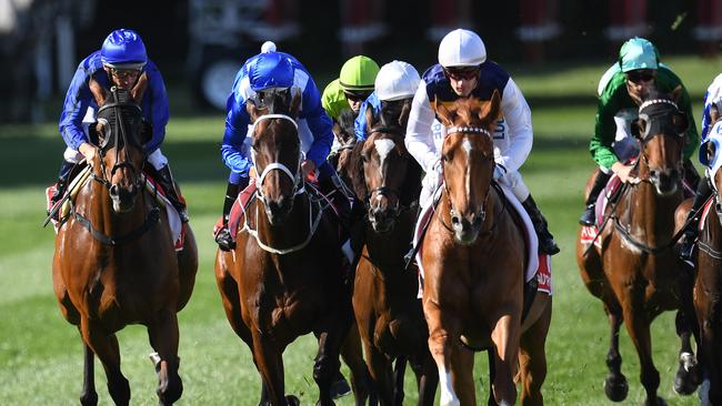 Damien Oliver (left) pilots Happy Clapper during his controversial ride in the Cox Plate. Picture: AAP