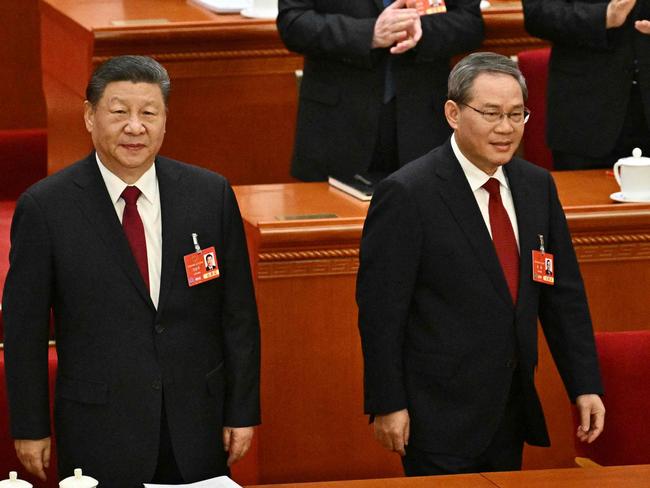 China's President Xi Jinping (L) and Premier Li Qiang attend the opening session of the National People's Congress (NPC) at the Great Hall of the People in Beijing on March 5, 2025. (Photo by Pedro Pardo / AFP)