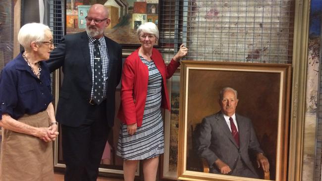 Rockhampton Art Gallery Trust past chair Merilyn Luck OAM with Rockhampton MP Bill Byrne and Rockhampton Mayor Margaret Strelow and the portrait of former Rockhampton mayor Rex Pilbeam inside the gallery's collection vault in 2017.