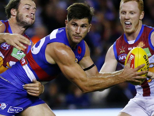 AFL: Round 5 Western Bulldogs V Brisbane Lions at Etihad Stadium, Western Bulldogs Koby Stevens gets tackled by Brisbane Lions' Josh Walker. 23rd April 2016. Picture: Colleen Petch.