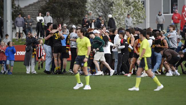 Cheltenham fans storm the ground after the win. Picture: Andrew Batsch