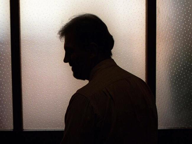 Generic image. Silhouette of a man (parent of) a sex abuse victim in an office. wrongly accused of touching young girl. Child sexual abuse. sex crime incest paedophilia.