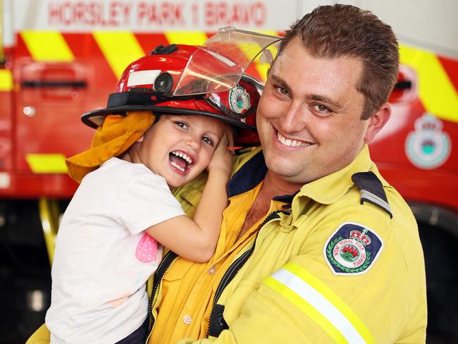 RFS volunteer firefighter Anthony Ciccaldo with his three-year-old daughter Abby. Picture: Tim Hunter.