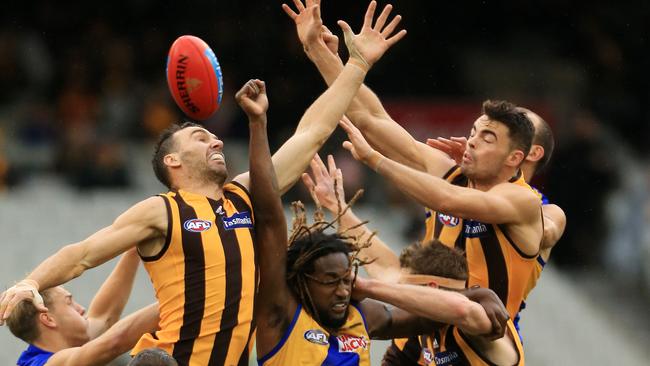 Hawthorn players fly for a mark against West Coast on Saturday in front of a small crowd. Picture: Mark Stewart.