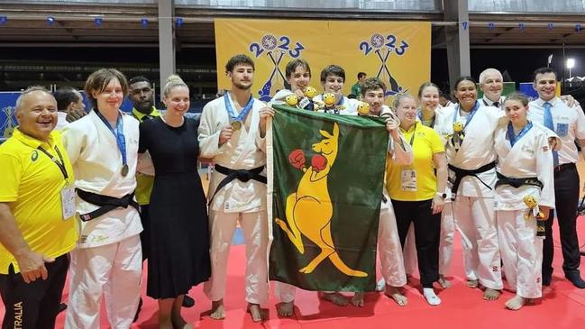 Alannah Joyce (second from left) with the Australian team after they won gold in the team event at the Pac Games. Picture: Darwin Judo Club