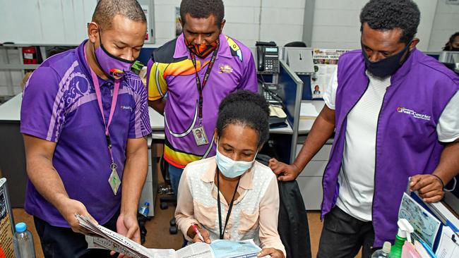 Post Courier Editor Matthew Vari (L) going over the Friday edition with Sports Editor Simon Keslep (2nd L), Education reporter Leiao Gerega (C), and Sports scribe Jonathan Sibona (R).