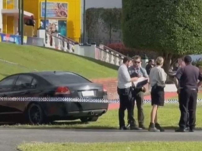 A black commodore has crashed into the Dreamworld entrance in suspected road rage incident. Picture: Nine News