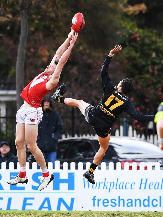 North's Craig Cameron cops one in the back from Ian Milera. Picture: Mark Brake/AAP