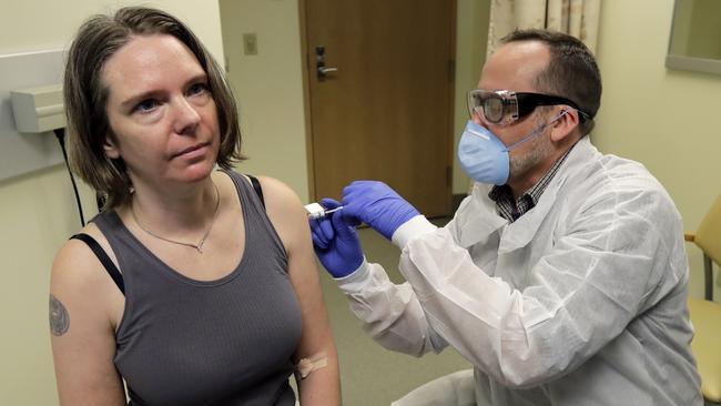 A pharmacist gives Jennifer Haller, left, the first shot in the first-stage safety study clinical trial of a potential vaccine for COVID-19. Picture: AP