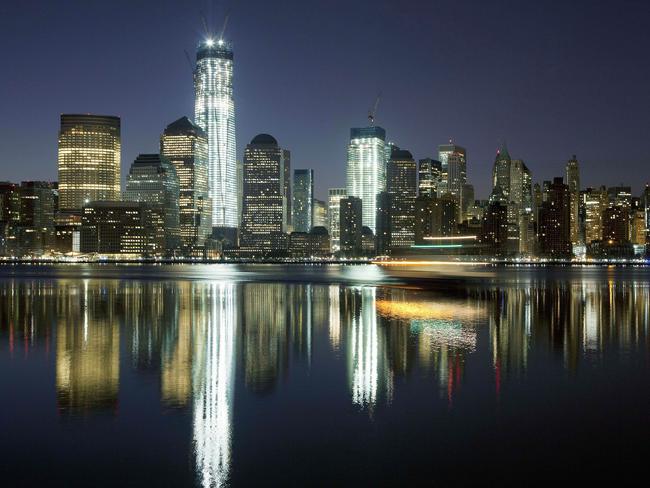 One World Trade Center lit up and towering over the Manhattan skyline. AP Photo/Mark Lennihan.