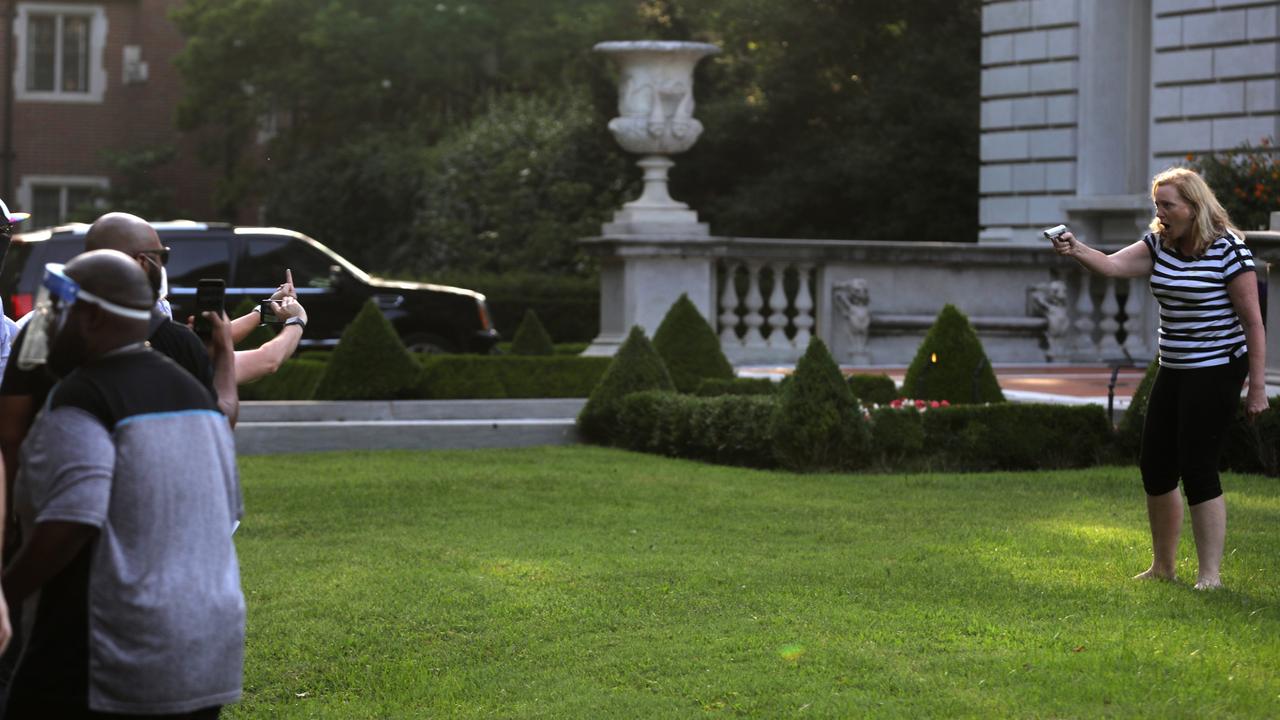 A prominent lawyer, Mrs McCloskey appears to point her weapon at the protesters from across her perfectly manicured lawn. Picture: Laurie Skrivan/ St. Louis Post-Dispatch/Polaris/australscope