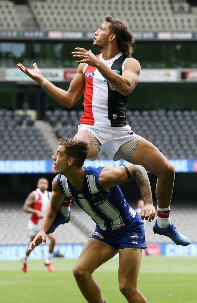 Ben Long flies to mark over Jy Simpkin of the Kangaroos. Picture: Michael Klein