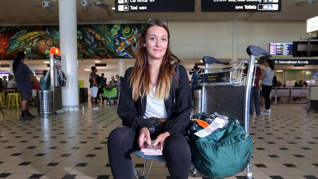 Camille Bonilla at the Brisbane international airport after catching one of the last flights into Brisbane. AAP Image/Richard Gosling