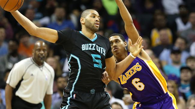 Nicolas Batum of the Charlotte Hornets keeps the ball from Jordan Clarkson of the Los Angeles Lakers during their game at Time Warner Cable Arena.