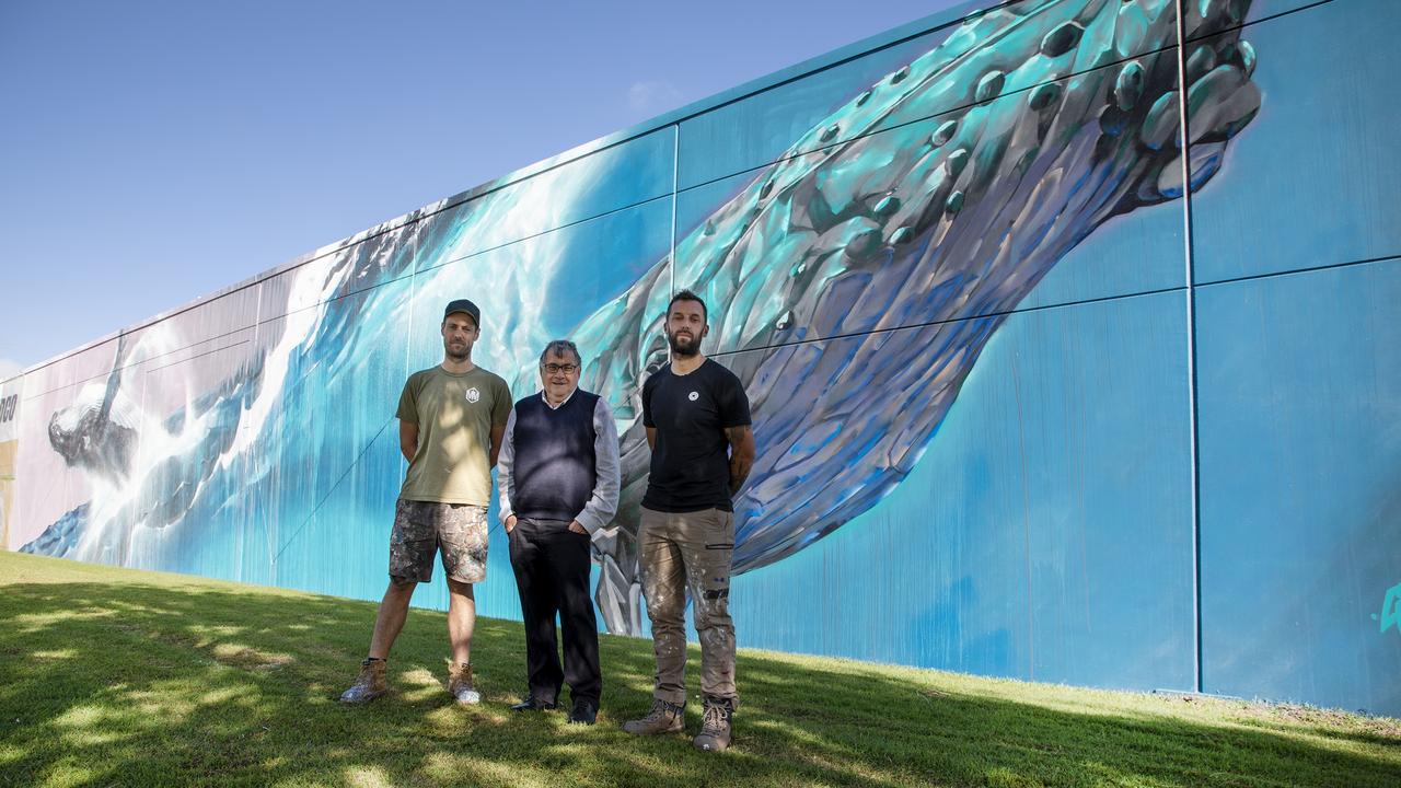 Artists Matt Thompson and Cam Scale with Fraser Coast Councillor David Lewis in front of the whale mural. Photo: Contributed.