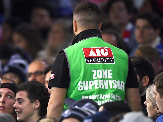 MELBOURNE, AUSTRALIA - JUNE 15: Security remove a member from the crowd during the round 13 AFL match between the Carlton Blues and the Western Bulldogs at Marvel Stadium on June 15, 2019 in Melbourne, Australia. (Photo by Quinn Rooney/Getty Images)