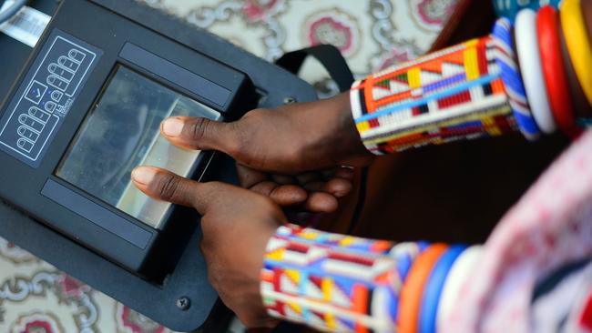 A Maasai woman has her fingerprints electronically recorded as she registers to vote in Kenya — one of many countries which uses now uses technology in some way during elections. Picture: Carl de Souza/AFP