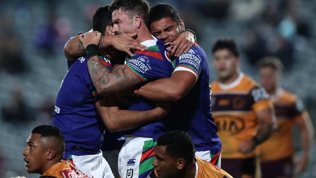 The Warriors celebrate a try that added salt to the Broncos’ wounds. Picture: Getty Images