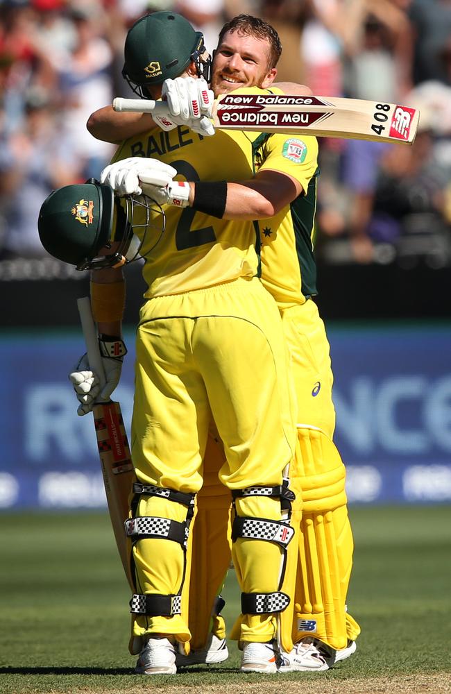 Aaron Finch celebrates his century with a hug from George Bailey.