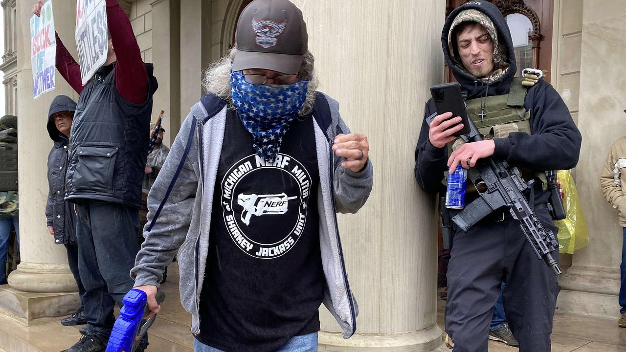 A Protester with a Nerf gun stands near an armed protester at the Michigan Capitol Building on May 14, 2020 in Lansing, Michigan. Picture: AFP