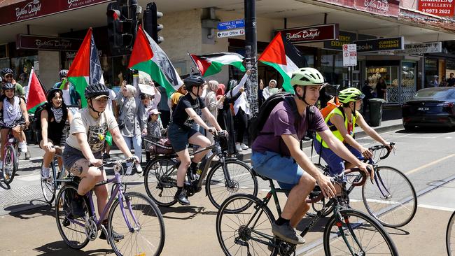 Dozens of cyclists joined the motorcade along Sydney Road Coburg. Picture: NCA NewsWire / Ian Currie