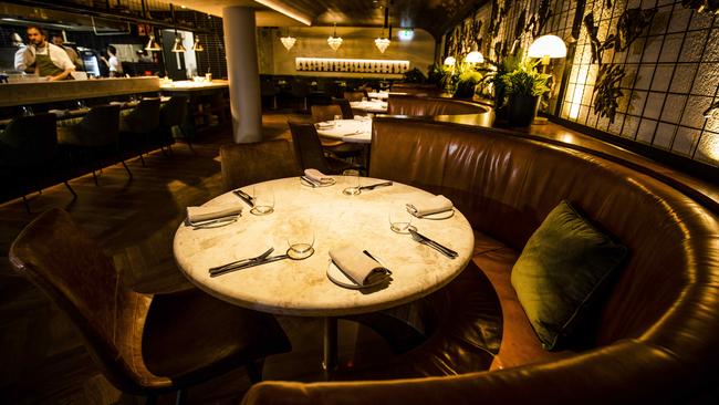 Settle in for the night: the moody restaurant and open kitchen