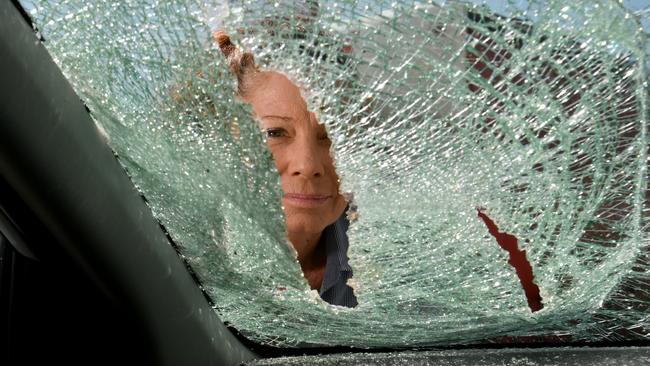 Debbie Thompson at Independent Network in Garbutt with vehicles damaged by a vandal. Picture: Evan Morgan