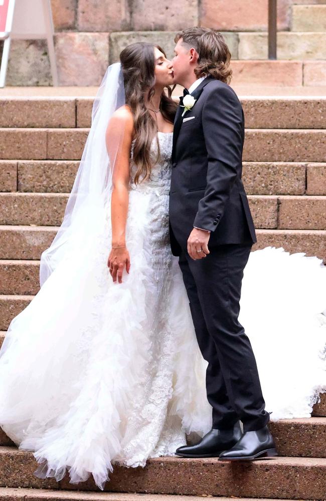 Cameron Smith and Shanel Naoum share a kiss on the steps outside Brisbane’s Cathedral of St Stephen.