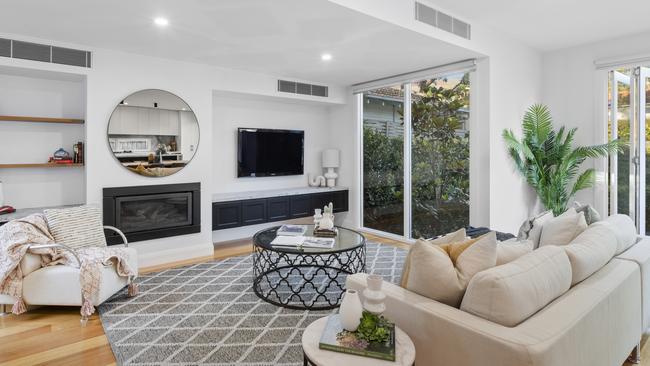 A gas fireplace and bespoke joinery in one of the living rooms.