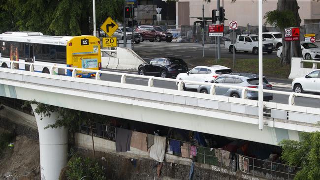Homeless encampments along the Brisbane River under the Riverside Expressway. Picture: NewsWire / Glenn Campbell
