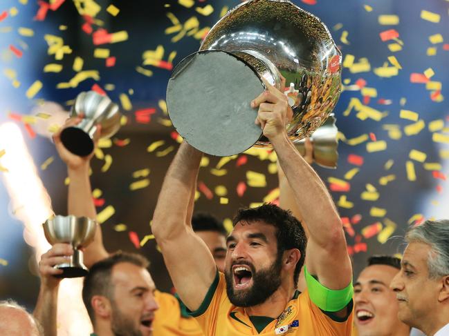 Australia's Captain Mile Jedinak lifts the trophy over his head after winning the Asian Cup Final between Australia and Korea Republic at Stadium Australia, Homebush. Picture: Toby Zerna