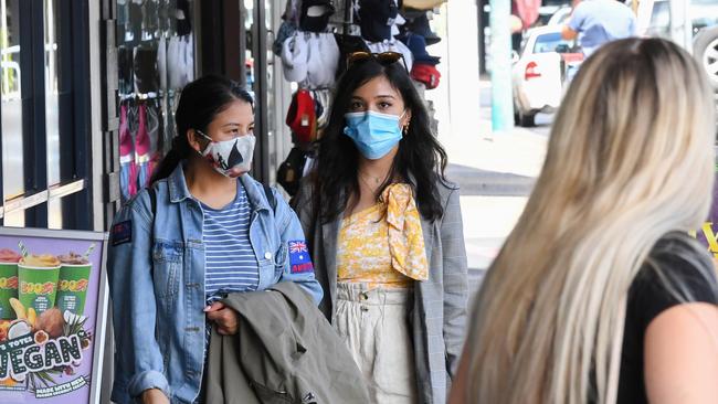 Covid-19 restrictions, like mask wearing as seen on this Byron Bay street, have been put in place as new coronavirus restrictions postpone and halt events. (Photo by James D. Morgan/Getty Images)