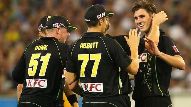 Pat Cummins (R) is congratulated after taking the wicket of South Africa’s Ryan McLaren.