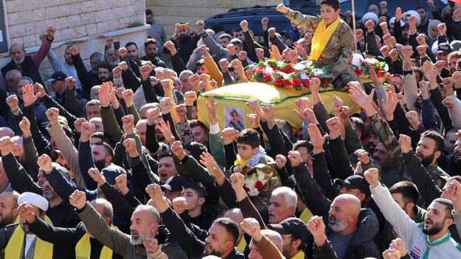 Mourners carry the body of a Hezbollah fighter killed during an Israeli strike in the southern Lebanese village of Meiss El-Jabbal. Picture: AFP.