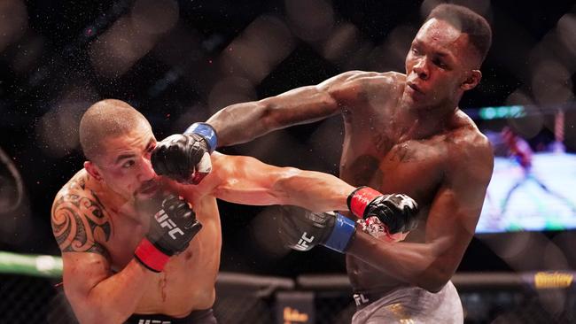 Israel Adesanya lands a blow on Robert Whittaker last October. Picture: AAP